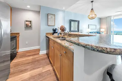 a kitchen with a sink and a counter top at Aqua Resort 905 by Emerald Coast Retreats in Panama City Beach