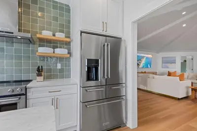 a kitchen with a stainless steel refrigerator and a living room at Happy to Sea You, Beach Access, Private Pool, Yard, Patio, Deck in Inlet Beach