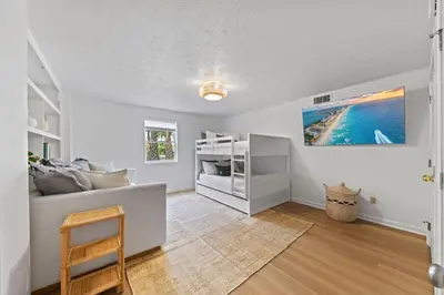 a living room with a couch and a bed at Happy to Sea You, Beach Access, Private Pool, Yard, Patio, Deck in Inlet Beach