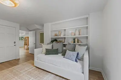 a living room with a white couch with pillows at Happy to Sea You, Beach Access, Private Pool, Yard, Patio, Deck in Inlet Beach