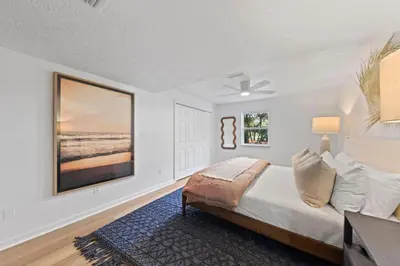 a bedroom with a bed and a painting on the wall at Happy to Sea You, Beach Access, Private Pool, Yard, Patio, Deck in Inlet Beach