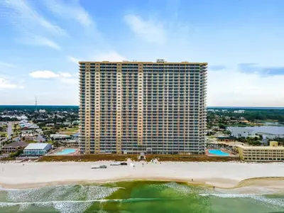 an aerial view of a large building on the beach at Stunning Beachfront Condo, Walk to Pier Park,Pools in Panama City Beach