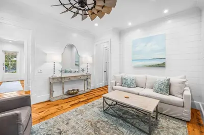 a living room with a couch and a table at One Second Away in Santa Rosa Beach