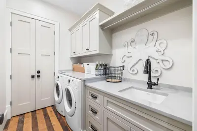 a kitchen with a sink and a washing machine at One Second Away in Santa Rosa Beach