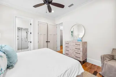 a white bedroom with a bed and a ceiling fan at One Second Away in Santa Rosa Beach