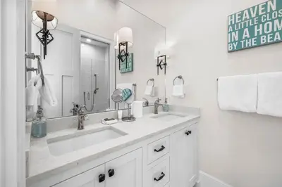 a white bathroom with a sink and a mirror at One Second Away in Santa Rosa Beach
