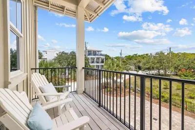 a porch with two chairs and a balcony with a view at One Second Away in Santa Rosa Beach