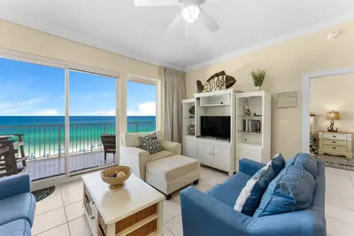 a living room with a view of the ocean at Treasure Island #0309 in Panama City Beach