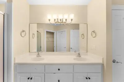 a bathroom with two sinks and a large mirror at Treasure Island #0309 in Panama City Beach