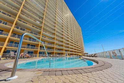 a large building with a swimming pool in front of it at Treasure Island #0309 in Panama City Beach