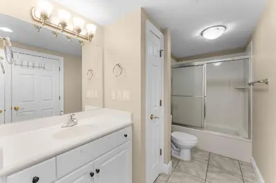 a white bathroom with a sink and a toilet at Treasure Island #0607 in Panama City Beach