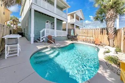a swimming pool in the backyard of a house at Seaside Serenity in Panama City Beach