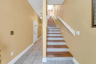 a hallway with stairs in a home at Seaside Serenity in Panama City Beach