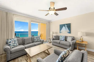 a living room with a couch and a ceiling fan at Treasure Island #1108 in Panama City Beach