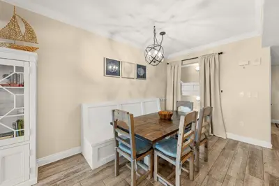 a dining room with a wooden table and chairs at Treasure Island #1108 in Panama City Beach
