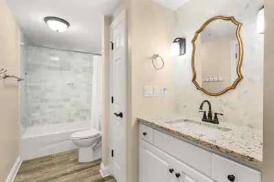 a bathroom with a sink and a toilet and a mirror at Treasure Island #1108 in Panama City Beach