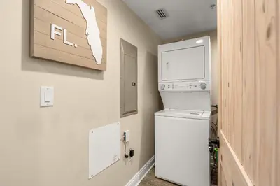 a small kitchen with a refrigerator and a microwave at Treasure Island #1108 in Panama City Beach