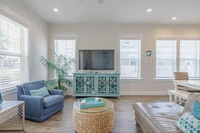 a living room with a couch and a tv at Southern Breeze - Private Pool - 100 Feet From The Beach! in Panama City Beach