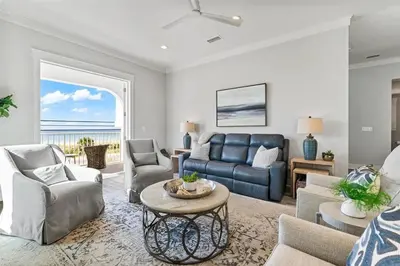 a living room with a couch and a table at Luxury Breeze - Luxury Home With Private Pool & Private Beach! in Panama City Beach