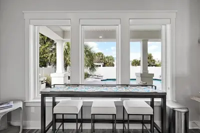 a dining room with a large table and chairs at Luxury Breeze - Luxury Home With Private Pool & Private Beach! in Panama City Beach