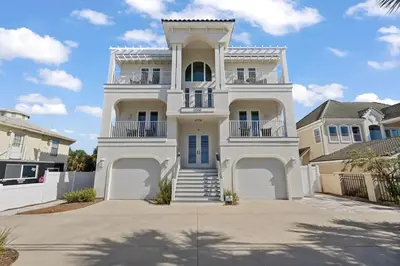 a large white house with a large driveway at Luxury Breeze - Luxury Home With Private Pool & Private Beach! in Panama City Beach