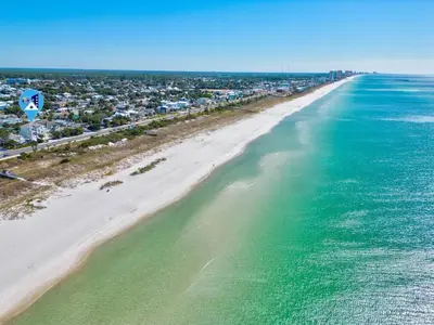 an aerial view of a beach with houses and the ocean at Luxury Breeze - Luxury Home With Private Pool & Private Beach! in Panama City Beach