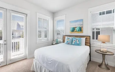 a white bedroom with a bed and windows at 12 Milestone Dr C by Oversee 30A in Inlet Beach