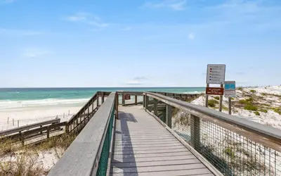 a wooden walkway to the beach with the ocean at 12 Milestone Dr C by Oversee 30A in Inlet Beach