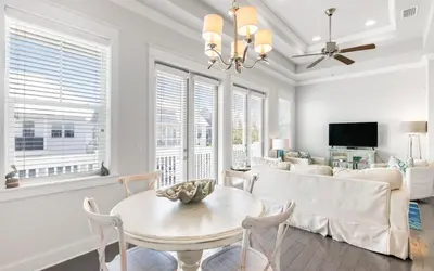 a living room with a white couch and a table at 12 Milestone Dr C by Oversee 30A in Inlet Beach