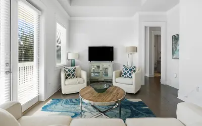 a living room with white furniture and a tv at 12 Milestone Dr C by Oversee 30A in Inlet Beach