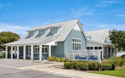 a blue building with a sign in front of it at 310 Grande Pointe by Oversee 30A in Inlet Beach