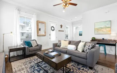 a living room with a couch and a table at 310 Grande Pointe by Oversee 30A in Inlet Beach