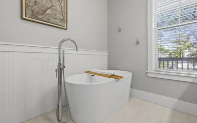 a white bathroom with a shower and a bath tub at 91 San Juan by Oversee 30A in Santa Rosa Beach