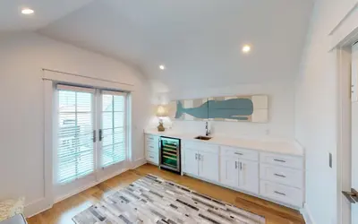 a kitchen with white cabinets and a large window at 94 Pinecrest by Oversee 30A in Inlet Beach