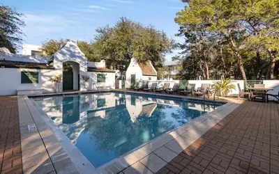a swimming pool in front of a house at 94 Pinecrest by Oversee 30A in Inlet Beach