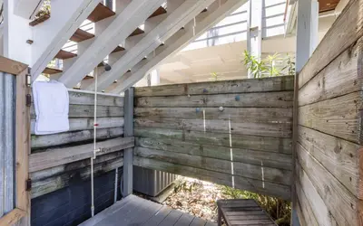a wooden patio with a wooden fence and a wooden bench at A Hasty Retreat by Oversee 30A in Seagrove Beach