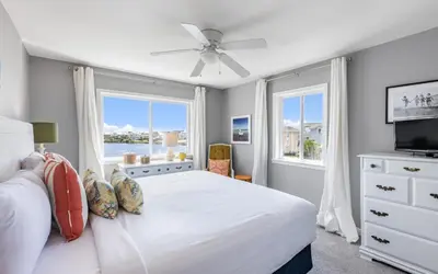 a white bedroom with a bed and a window at A Hasty Retreat by Oversee 30A in Seagrove Beach