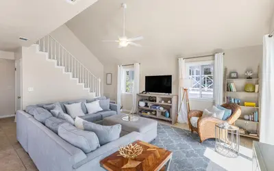 a living room with a couch and a tv at A Hasty Retreat by Oversee 30A in Seagrove Beach