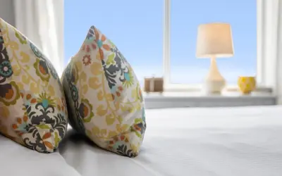 two pillows on a bed with a lamp in a room at A Hasty Retreat by Oversee 30A in Seagrove Beach