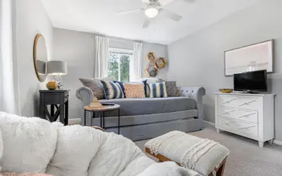 a living room with a couch and a tv at A Hasty Retreat by Oversee 30A in Seagrove Beach