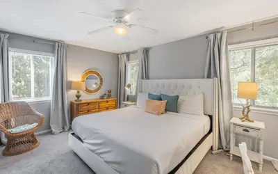 a bedroom with a bed and a ceiling fan at A Hasty Retreat by Oversee 30A in Seagrove Beach