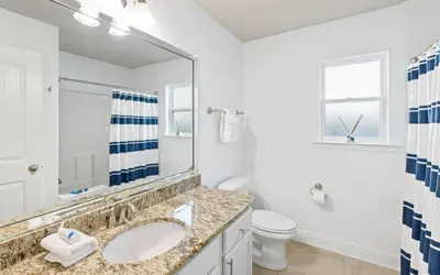 a bathroom with a sink and a toilet at After Dune Delight by Oversee 30A in Inlet Beach