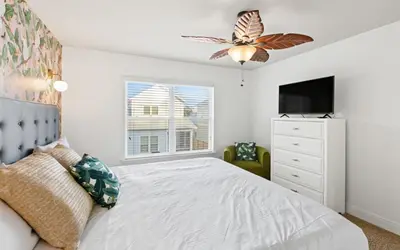 a bedroom with a bed and a tv and a window at After Dune Delight by Oversee 30A in Inlet Beach