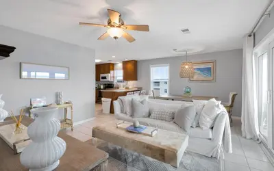 a living room with a couch and a table at Aqua Bella by Oversee 30A in Santa Rosa Beach