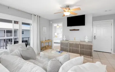a living room with a white couch and a ceiling fan at Aqua Bella by Oversee 30A in Santa Rosa Beach