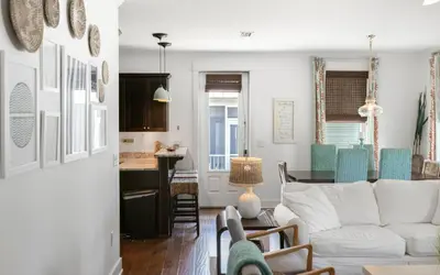 a living room with a white couch and a table at Beach Bike Bungaleaux by Oversee 30A in Seacrest