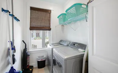 a laundry room with a washing machine and a window at Beach Bike Bungaleaux by Oversee 30A in Seacrest