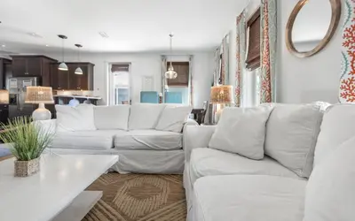 a living room with white couches and a table at Beach Bike Bungaleaux by Oversee 30A in Seacrest