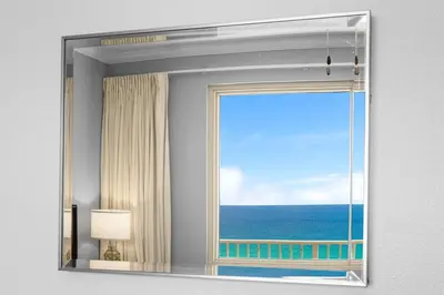 a mirror in a room with a view of the ocean at Shores of Panama Chic 2-BD Beachfront Resort Condo! by Dolce Vita Getaways! in Panama City Beach