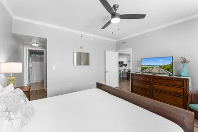 a bedroom with a bed and a flat screen tv at Shores of Panama Chic 2-BD Beachfront Resort Condo! by Dolce Vita Getaways! in Panama City Beach